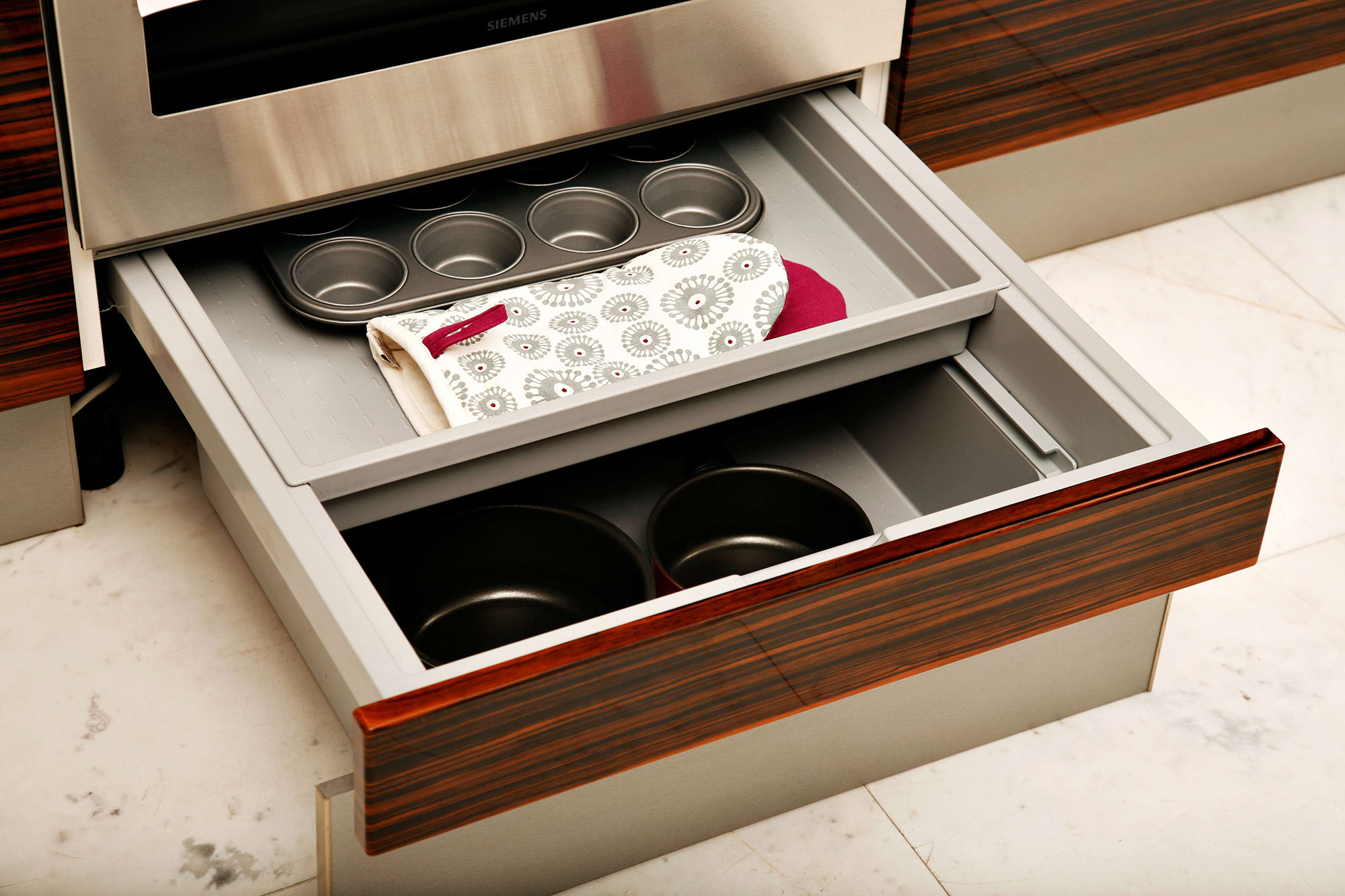 Storage shelves extended underneath a stove.